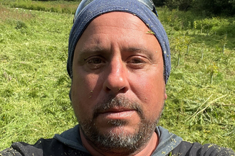 Jez Squire close up of face with background of meadow habitat