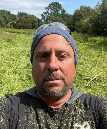 Jez Squire close up of face with background of meadow habitat